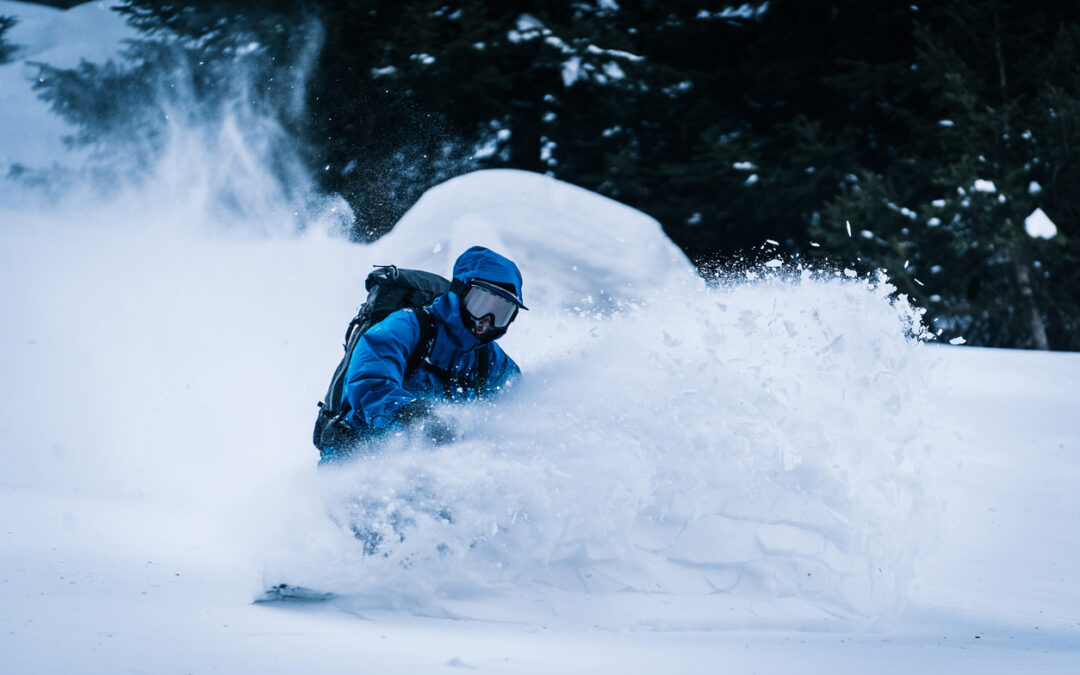 Backcountry snowboarder descends mountain