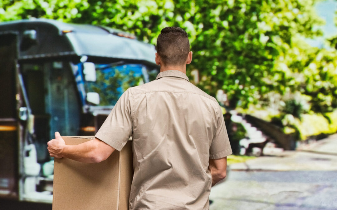 Delivery man carrying cardboard box